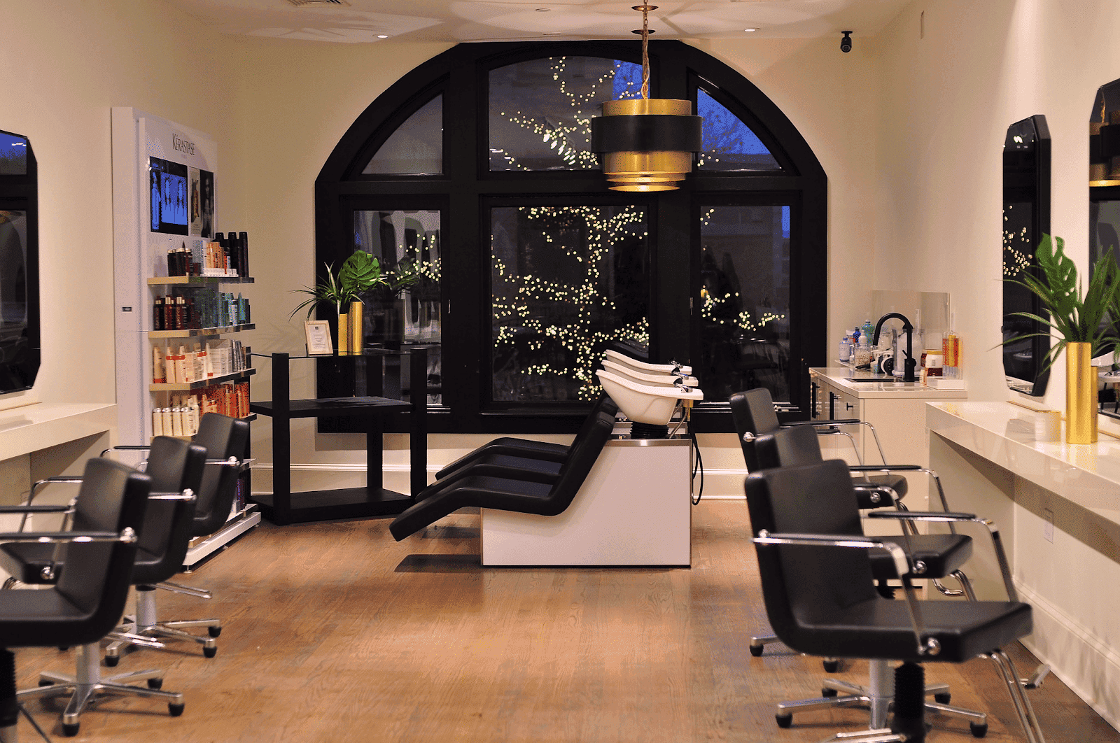 Modern hair salon interior with styling chairs and hair products.