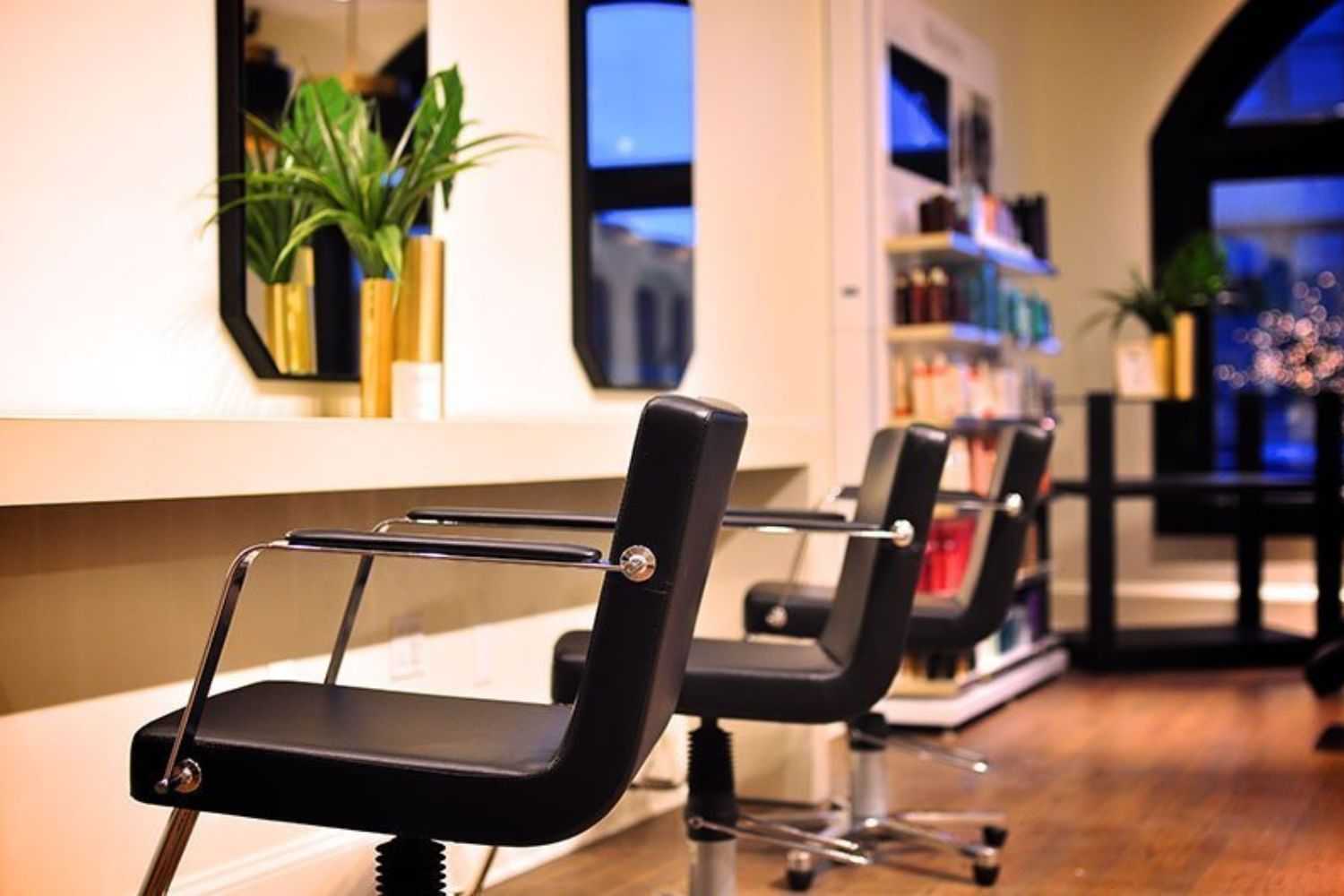 Modern salon with stylish black chairs and a bright, inviting atmosphere.